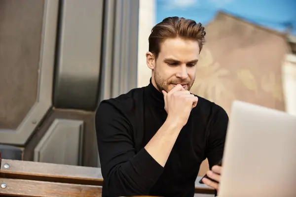 Handsome man reflects thoughtfully while seated on a bench, enjoying a sunny day outdoors. — Stock Photo