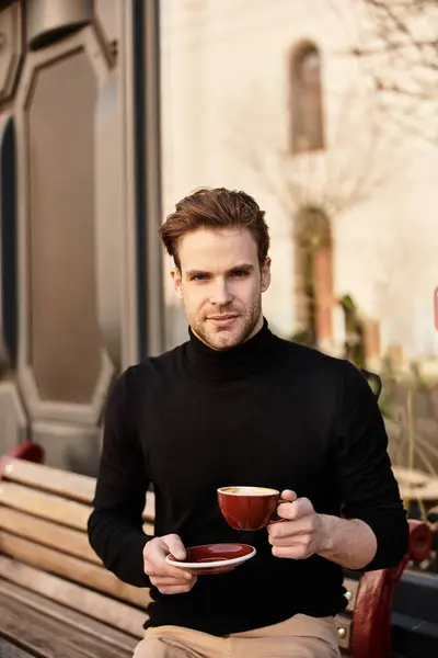 Stylish man savors his coffee break on a sunny day in a lively city environment. — Stock Photo