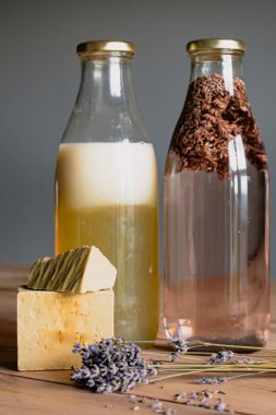 Bottles of homemade laundry on a table, Marseille grated soap, DIY, do it yourself, zero waste, eco friendly, natural product for wash and cleaning