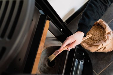 Adam fırçayla topağı temizliyor.