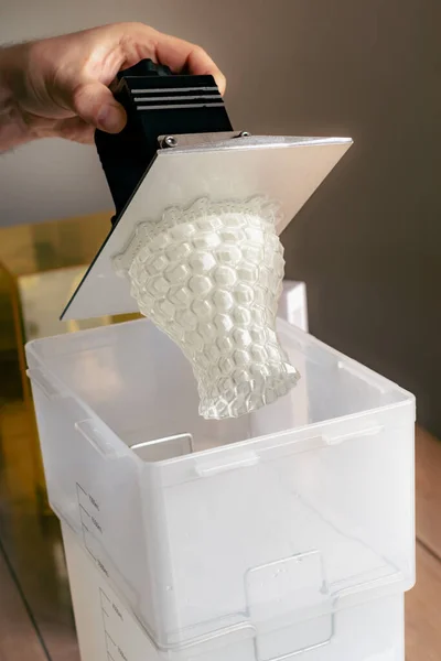 stock image Man using a wash machine to clean a transparent 3d resin object