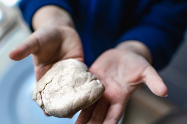 Çocuk hamuru modellerken eğleniyor, motor becerilerini geliştirmek için otantik aktiviteler yapıyor.