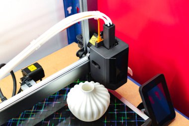 Four heads 3d printer, four extruders with an object on the tray, pla filament clipart