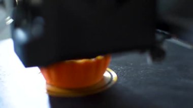 3D yazıcı, tepsiye iplik, mısır nişastası ve su geçirmez iplik içeren bir nesne basıyor.