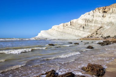 View of the limestone white cliffs with the beach at Stair of the Turks or Turkish Steps near Realmonte in Agrigento province. Sicily, Italy 