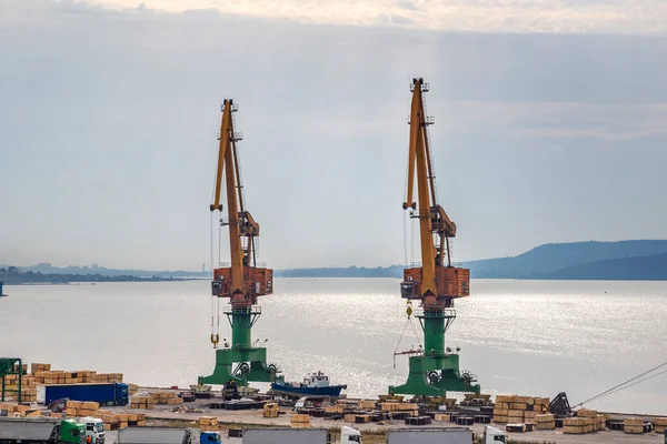 Two giant Port cranes are ready to load grain from cargo ships. horizontal view