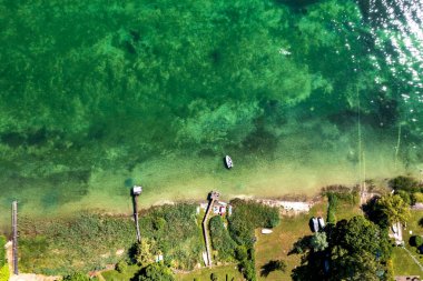 Aerial top view of the lake coast and piers. Beautiful coastline Bodensee lake