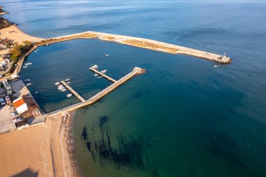 Aerial top view from drone to the seacoast and small marina with boats and yachts.	