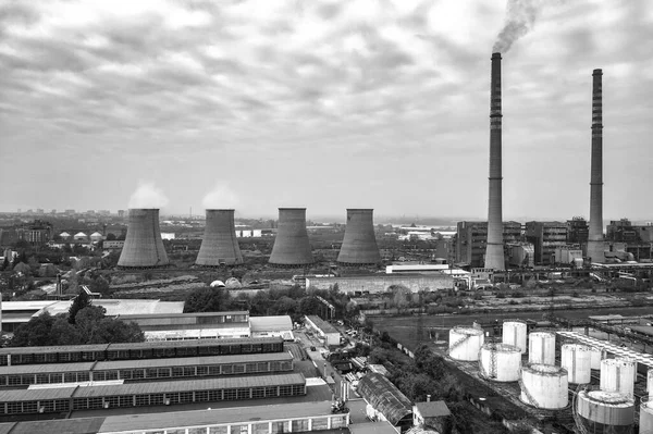 A black and white view of Coal Power Plant with large Chimneys