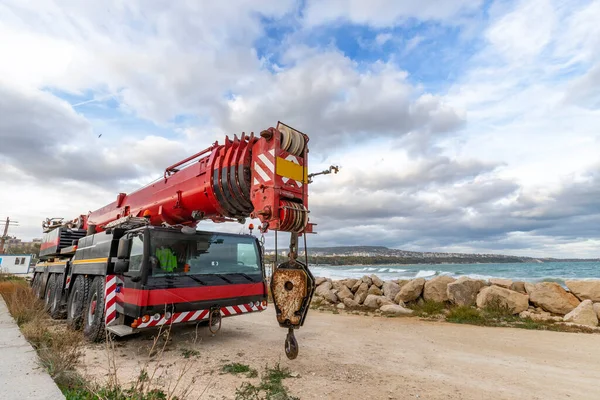 Heavy duty mobile crane parked near the sea. Telescopic truck mounted crane