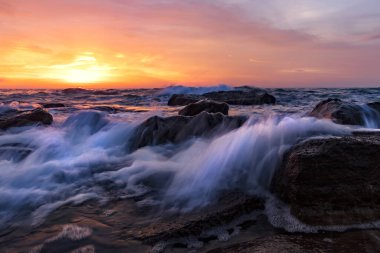 Sabahleyin Karadeniz kıyısında bir deniz suyu serpintisi. Güzel hareket bulanık deniz dalgaları kayaların üzerinde. 