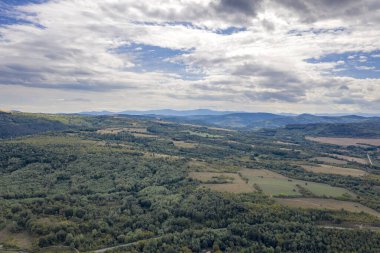 vast aerial view from the drone to the countryside with agricultural fields. 