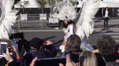 Carnival flower parade in Nice. A beautiful and noisy holiday on the azure coast. Giant dolls, flower battles. A crowd of people at the festival. Flowers are falling on heads