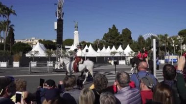 Carnival flower parade in Nice. A beautiful and noisy holiday on the azure coast. Giant dolls, flower battles. A crowd of people at the festival. Flowers are falling on heads