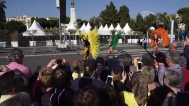 Carnival flower parade in Nice. A beautiful and noisy holiday on the azure coast. Giant dolls, flower battles. A crowd of people at the festival. People on horseback.