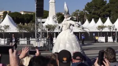 Carnival flower parade in Nice. A beautiful and noisy holiday on the azure coast. Giant dolls, flower battles. A crowd of people at the festival. People on horseback.