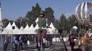 Carnival flower parade in Nice. A beautiful and noisy holiday on the azure coast. Giant dolls, flower battles. A crowd of people at the festival. People on horseback.