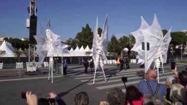 Carnival flower parade in Nice. A beautiful and noisy holiday on the azure coast. Giant dolls, flower battles. A crowd of people at the festival. People on horseback.