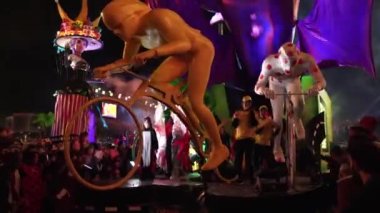 Carnival in Nice. Parade of light. Colorful images in masks. Tourists from all over the world. Parade of platforms. Papier-mch dolls, platform movement. Young dancers
