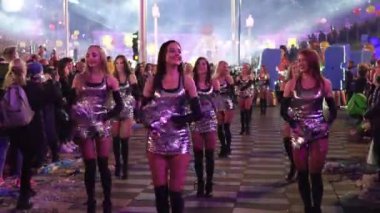 Carnival in Nice. Parade of light. Colorful images in masks. Tourists from all over the world. Parade of platforms. Papier-mch dolls, platform movement. Cheerleader dancing