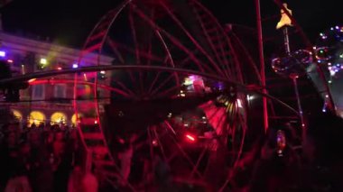 Carnival in Nice. Parade of light. Colorful images in masks. Tourists from all over the world. Parade of platforms. Papier-mch dolls, platform movement.Artist in a metal wheel