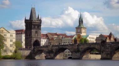 Charles Bridge in Prague over the Vltava River, connecting the historical districts of Mala Strana and Old Town. Srednevikovy stone bridge on which people walk