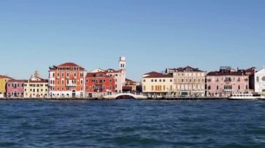 Panoramic view of Venice from a sailing boat. Beating waves on the coast of Venice. Ships sail near the coast of Venice. Panoramic view of the city from the sea. Jezuiti Church. Church in Venice