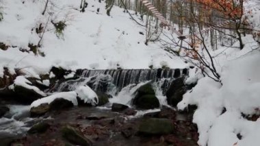 Polonyna Borzhava dağının kuzey yamaçlarında, Ukrayna Karpatları 'ndaki Gemba Dağı eteklerinde bir şelale. Shypit şelalesi. Ukrayna dağlarında kış