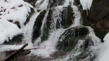A waterfall on the northern slopes of the Polonyna Borzhava mountain massif at the foot of Mount Gemba in the Ukrainian Carpathians. Shypit waterfall. Winter in the mountains of Ukraine