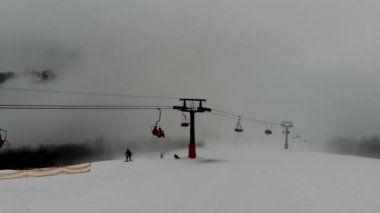 Shot from the drone of the funicular to the Himba mountain. Ski resort Pylypets in the Carpathians of Ukraine. Prepared tracks for skiers and snowboarders. The longest ski run in Ukraine. Cableway