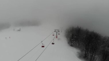 Shot from the drone of the funicular to the Himba mountain. Ski resort Pylypets in the Carpathians of Ukraine. Prepared tracks for skiers and snowboarders. The longest ski run in Ukraine. Cableway