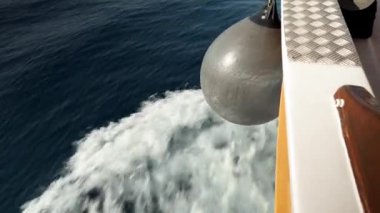 Hırvat Adriyatik Denizi 'nde yat gezisi. Kız geminin kıç tarafında yatıyor ve Adriyatik Denizi 'ndeki telefona bakıyor.