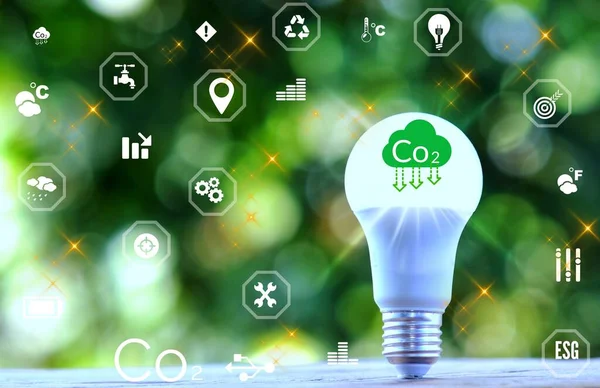 light bulb against nature with icons. Reduce CO2 emission concept. green business based on renewable energy.