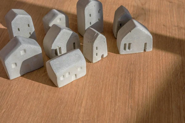 Mini house models on wood table, selective focus, Planning to buy property. Choose what\'s the best. A symbol for construction ,ecology, loan concepts.