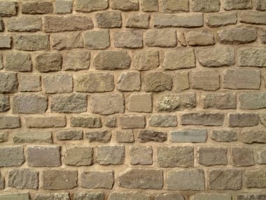 Eski yıpranmış taş duvar. Eski duvarın tarihi dokusu.