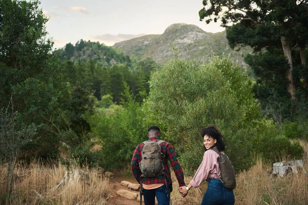 Smiling Young Multiethnic Couple Holding Hands While Hiking Together Path Stock Photo