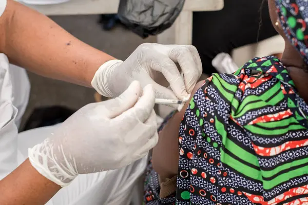 stock image Medical personnel administered an injection to a woman during a medical outreach event organized by the Lagos Island Local Government Chairman in Lagos, Nigeria, on February 17, 2022.