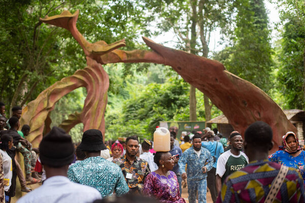 People walk in and out of the Sacred Groove during the annual Osun Osogbo Festival held in Osun State, Nigeria - West of Africa on Friday, August 9 2024