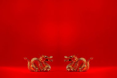 Kırmızı arka planda fotokopi alanı olan altın ejderha. Ejderha Çin Yeni Yılı 2024 konsepti. Altın ejderhalar birbirlerine dönük, 3D görüntüleme.