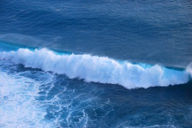 Mavi deniz deniz okyanusu, bulanık arka planda tropikal dev bir dalga. Açık havada deniz mavisi okyanus beyaz dalgası hareketi. Aqua marine dev dalga deniz yaz arkaplanı. Turkuaz cennet su manzarası