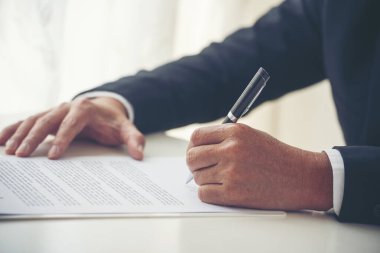 Asian business man using pen signing on new contract to starting projects in conference room. Close up manager businessman hands sign contract working meeting. Business agreement concepts.
