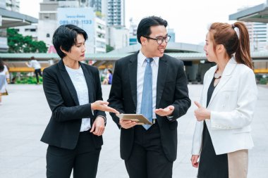 Business Woman Partner talk, meeting team Partnership in modern city together. Diversity Asian Business Partner online meeting trust teamwork. Asian Two Business people teams meeting outdoor in city.