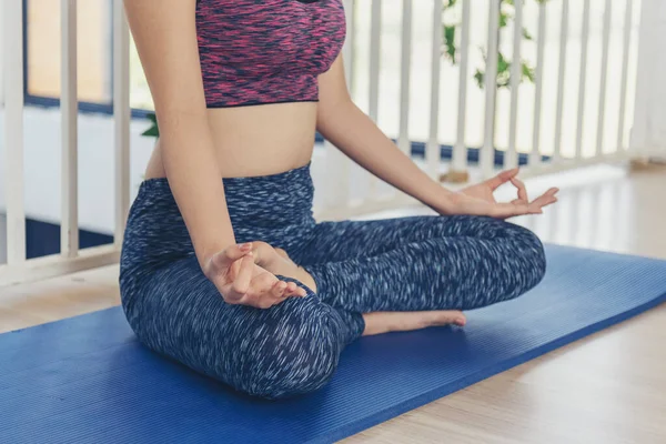 Asana yoga Beautiful woman smiling in sportswear sitting on yoga mat home fitness happy wellness lifestyle. Smiling asian woman doing asana yoga body, leg stretching in living room home fitness sport