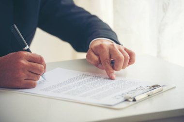 Asian business man using pen signing on new contract to starting projects in conference room. Close up manager businessman hands sign contract working meeting. Business agreement concepts.