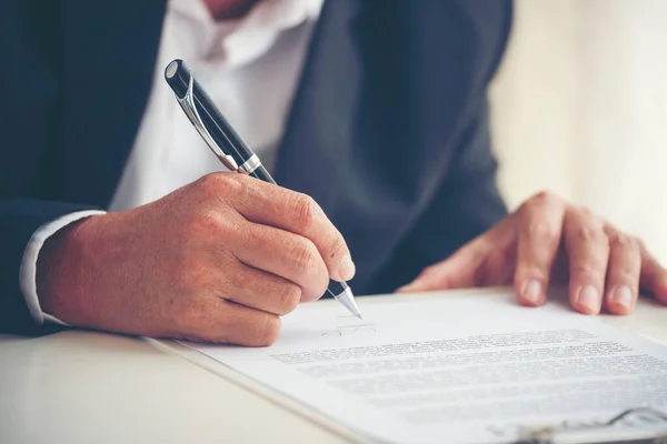 Businessman hand using pen signing on new contract to starting projects in conference room. Close up business manager man hands sign contract legal document in meeting room. Business agreement concept