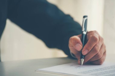 Asian business man using pen signing on new contract to starting projects in conference room. Close up manager businessman hands sign contract working meeting. Business agreement concepts.