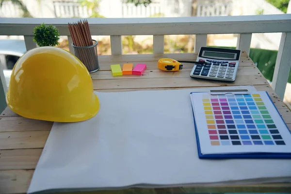 construction engineer office desk architect workplace. engineer drawing objects table with meter, blueprint, hard hat engineering stuff on desk. Designer Objects drafting workplace on wooden table.