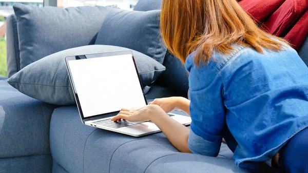 Happiness Asian Woman working from home using laptop online meeting in home office. Happy relax time asian business woman typing keyboard use notebook laptop Smiling, laughing at home office.
