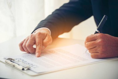 Asian business man using pen signing on new contract to starting projects in conference room. Close up manager businessman hands sign contract working meeting. Business agreement concepts.