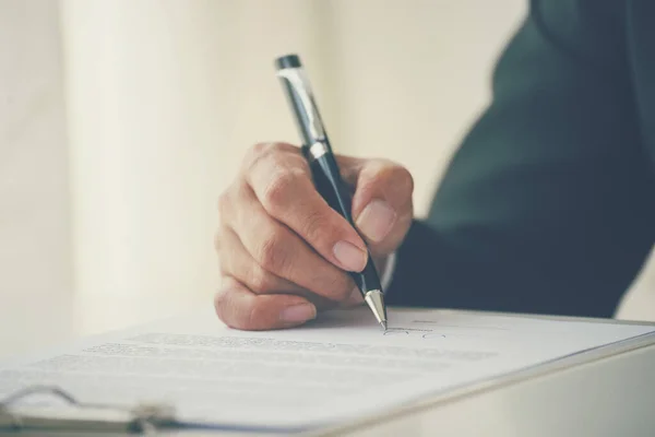 Asian business man using pen signing on new contract to starting projects in conference room. Close up manager businessman hands sign contract working meeting. Business agreement concepts.